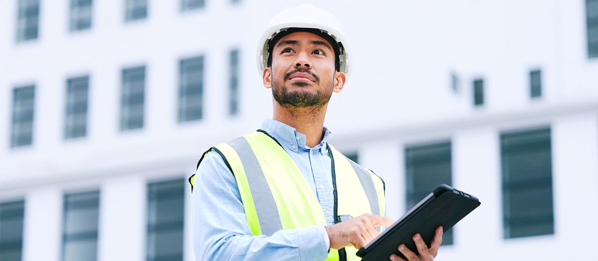 Man using permitting software on a tablet for an inspection